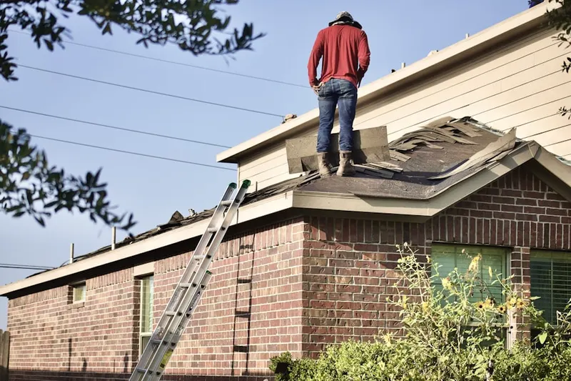 Professional roofer working on a residential roof in Adventure Town Center